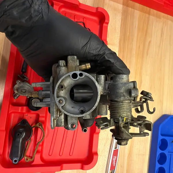 Secondary carb from the engine side with the throttle return spring visible on the right.