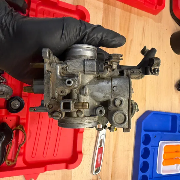 Primary carb body, bowl removed, showing the jets and the accelerator pump passage.