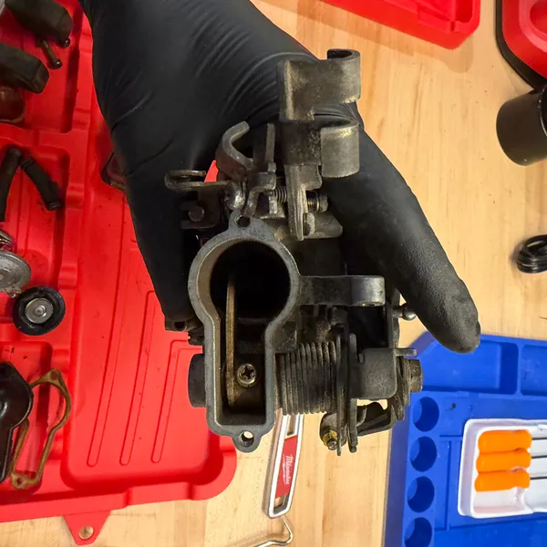 Same, other side. The small screw is the throttle stop.