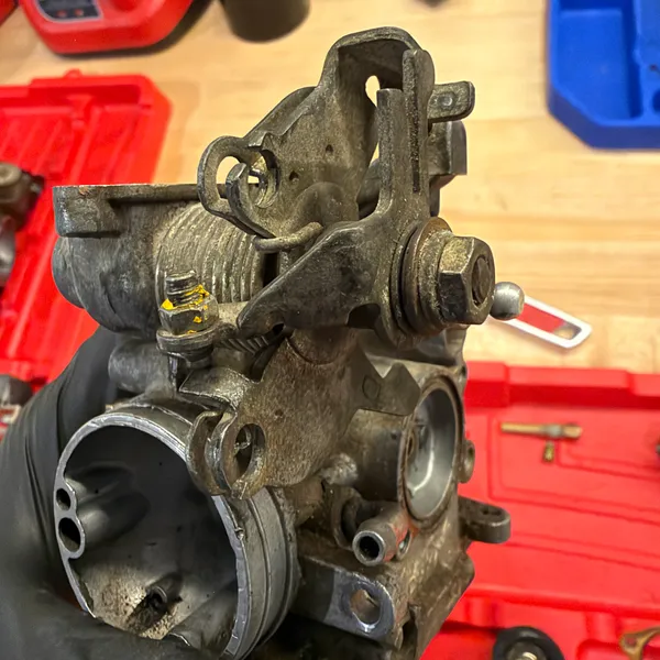 Linkage bracket and the cable stop, separated from the body.
