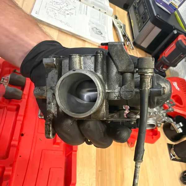 Looking through the primary bore with the throttle cable still attached. Butterfly slightly open.