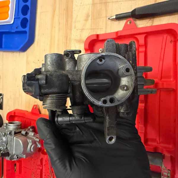 Primary, airbox side, showing the three small passages above the bore. Those need to be clear.