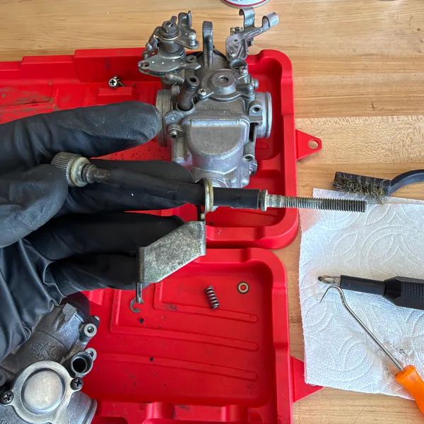 Cleaning the jet needle. Paper towel, brass brush, carb cleaner. Don't scratch the taper.