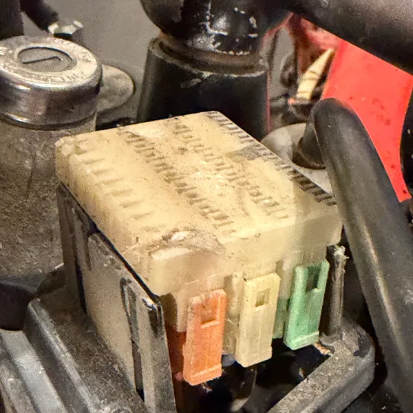 Connector block in its cradle, looking down past the fork. The ignition switch is at top left.