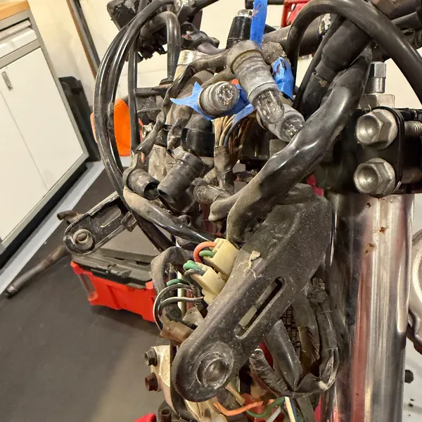 Front end from the right with the headlight off. Harness bundle hanging where the shell used to be.