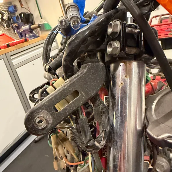 Right side headlight stay and the throttle cable routing over the top clamp.