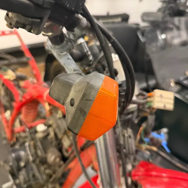 Right front turn signal, same mount, with the cable bundle running past it.
