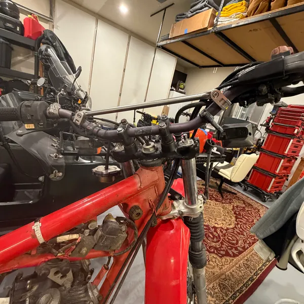 Wider, same angle. Front end mostly bare. Garage mates in the background.