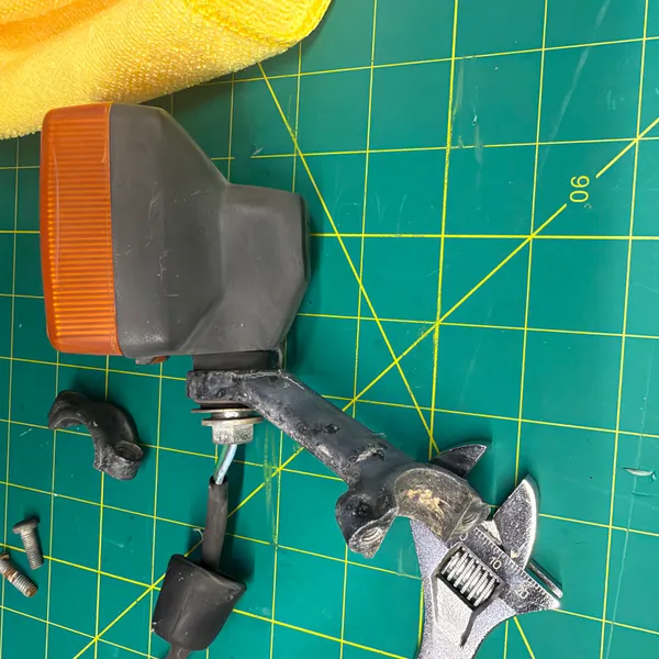 Same, with the rubber grommet and the two mounting screws laid out.