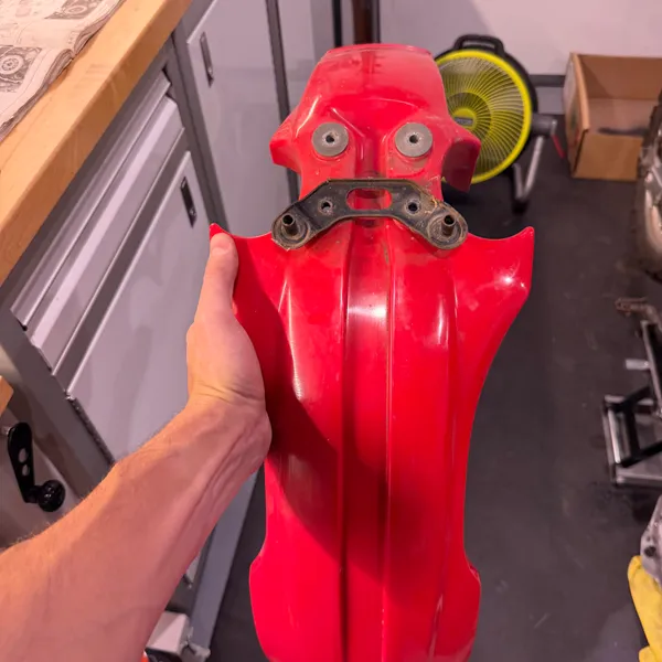 Front fender off. Bracket still attached, showing the four bolt holes that go to the lower triple clamp.