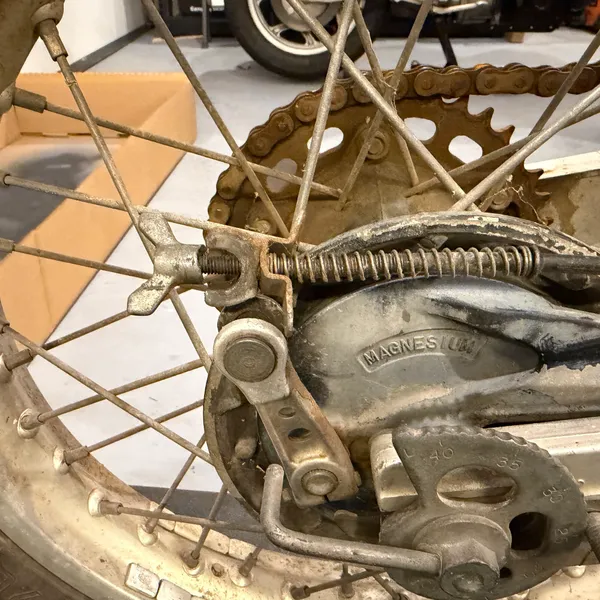 Closer on the brake arm, spring and rod end. Note the orientation of the spring hook.